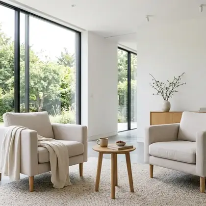 A bright minimal lounge with pale armchairs